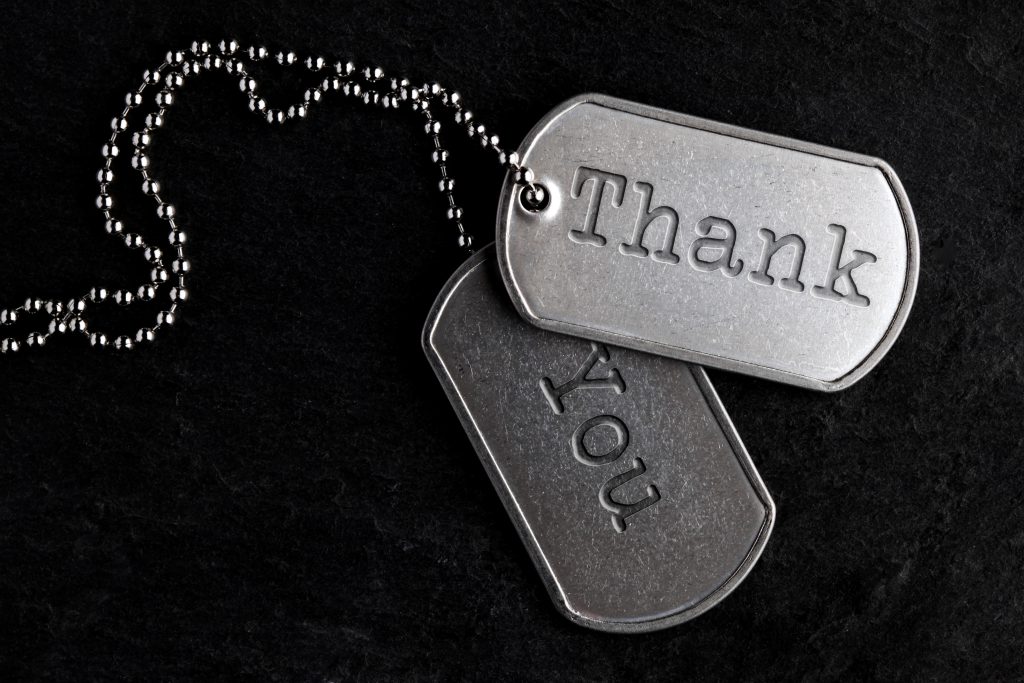 A pair of military dog tags stamped 'Thank You'.