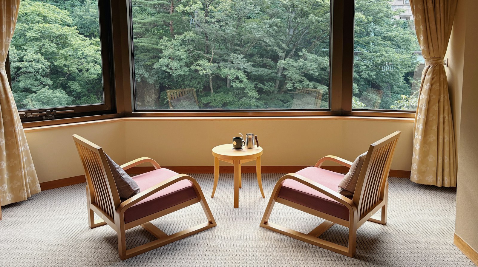 Two armchairs facing each other beside a window